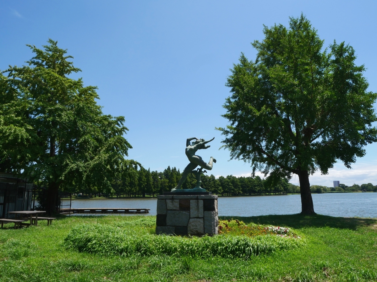 夏の日差しを浴びる水元公園のシンボルの銅像