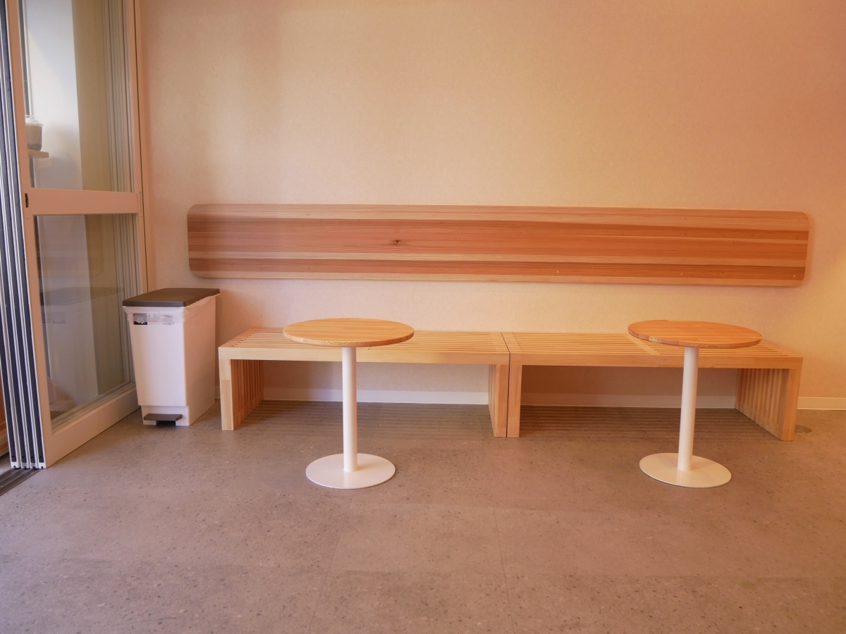 壁沿いに設置されたベンチと丸テーブル