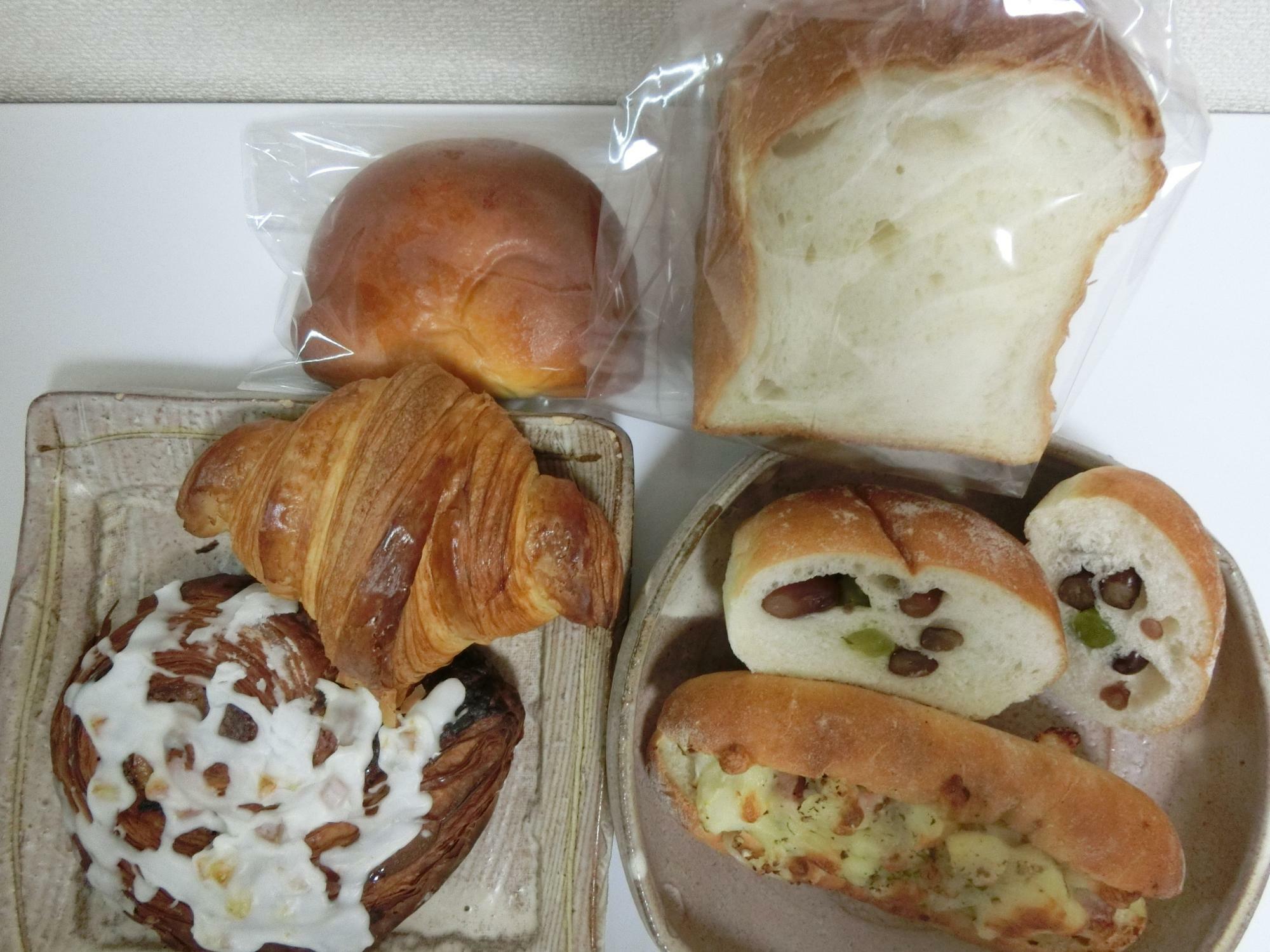 左上からブリオッシュクリームパン、その下がクロワッサン、左下がシナモンロール、右上が食パンハーフ、その下が３種の豆パン、右下がジャーマンポテト