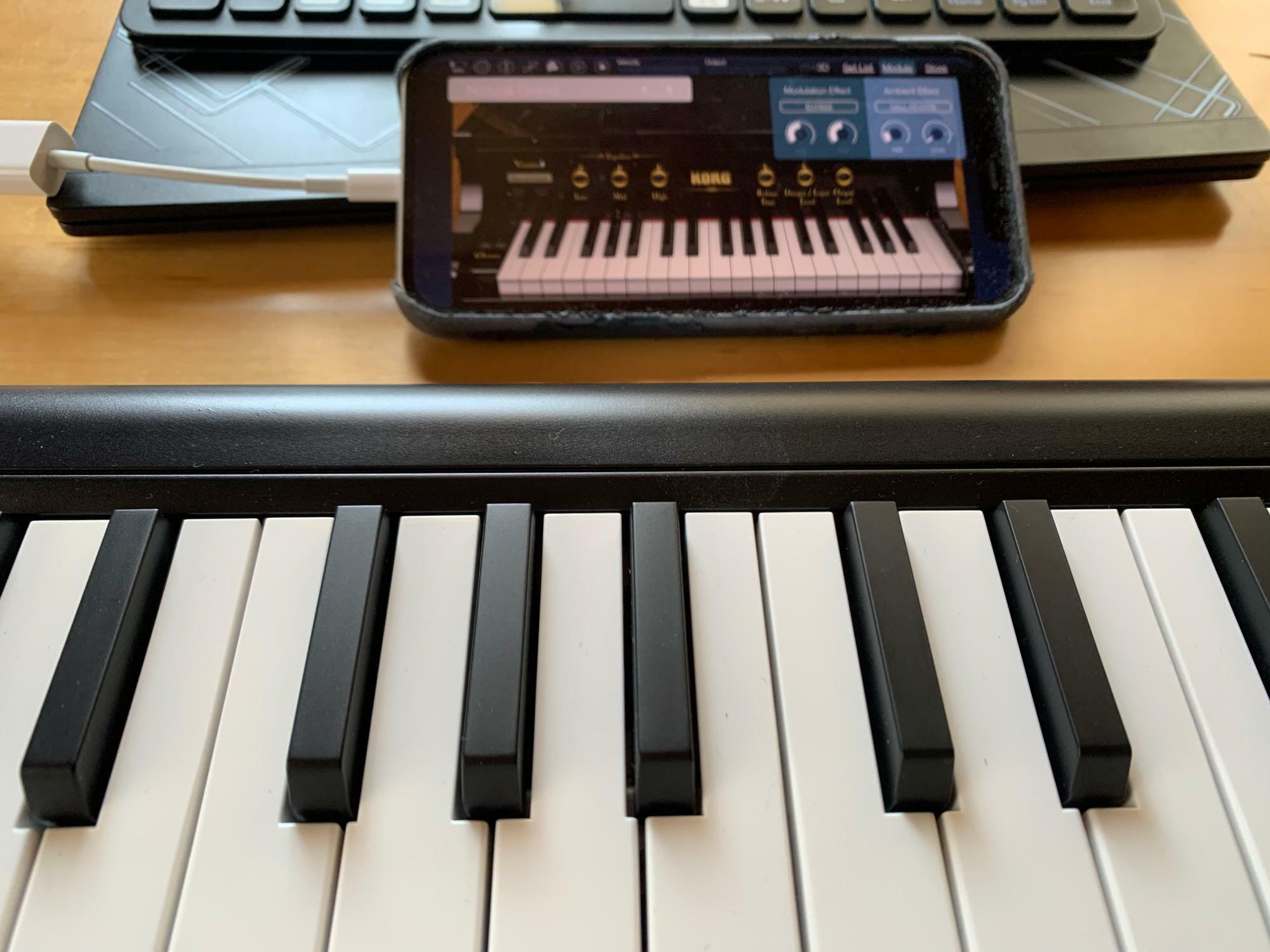 MIDIキーボードにiPhoneを接続したところ。専用のアダプターを用いる