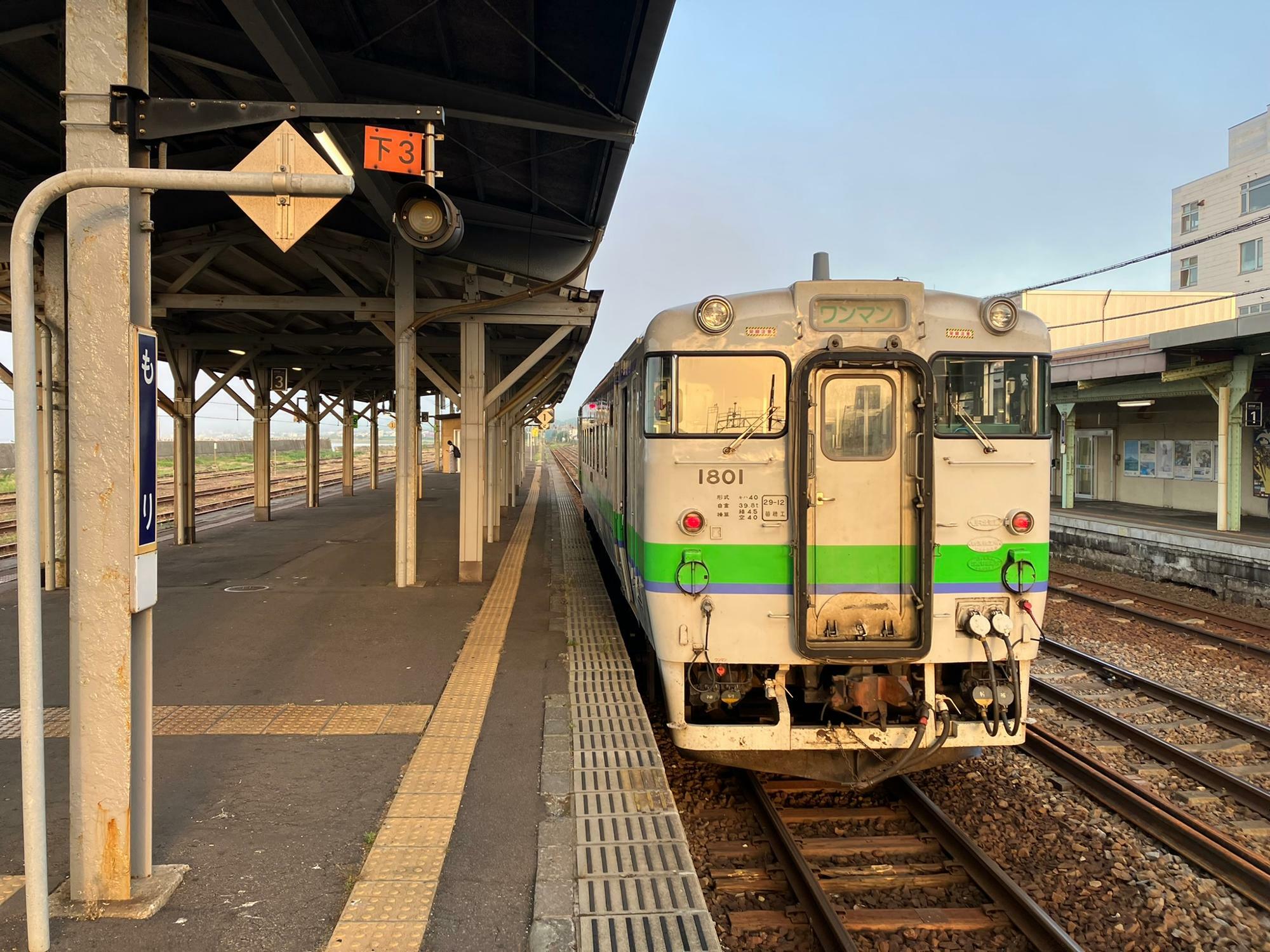 夕日に照らされて森駅で発車を待つ函館行普通列車（筆者撮影）