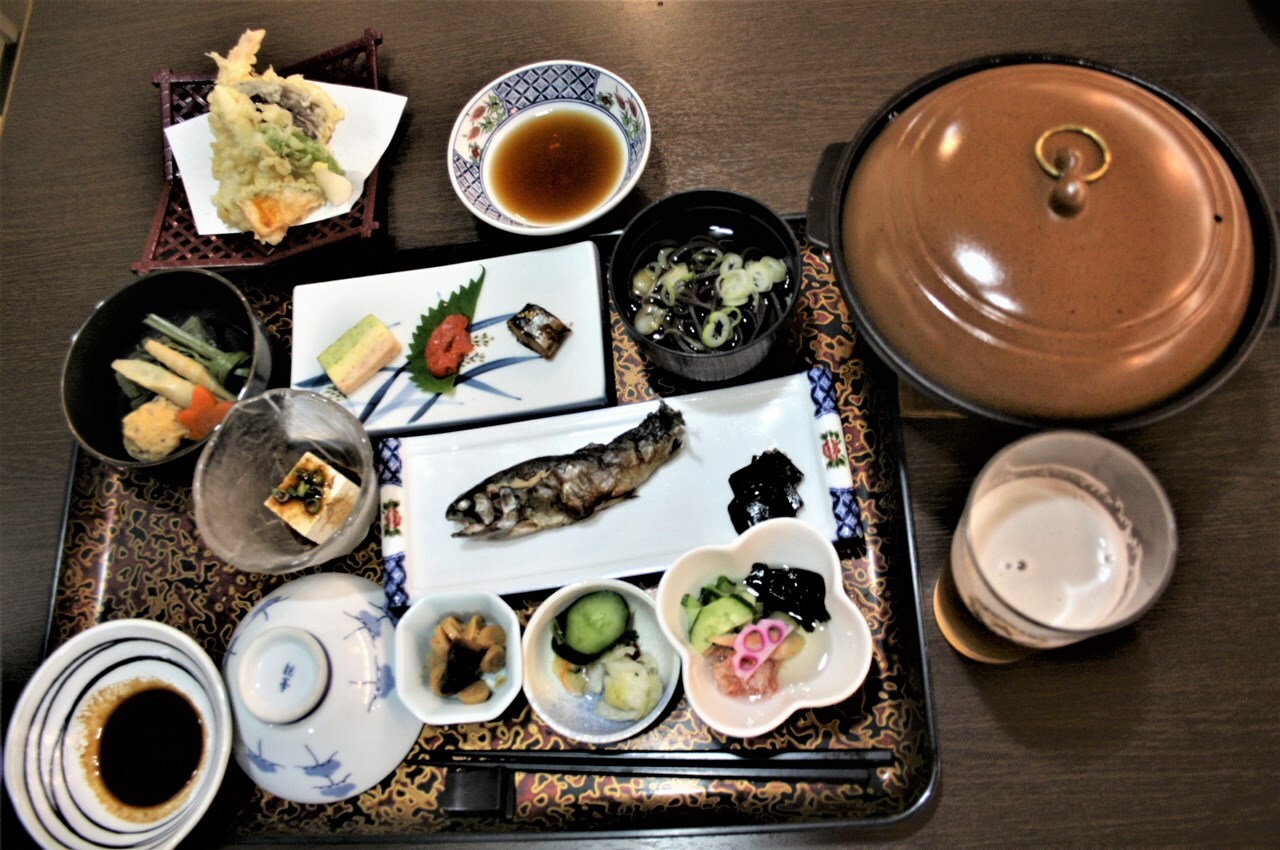 山菜と鮎などの天塩川温泉の夕食。これに黒い麺が特徴の音威子府そばがついた。