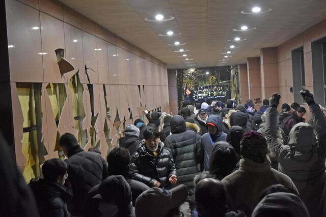 韓国大統領逮捕状発付で支持者激怒、裁判所襲撃の一部始終 ソウル西部地裁の敷地に侵入し、警察と対峙する人々。左は破壊された壁