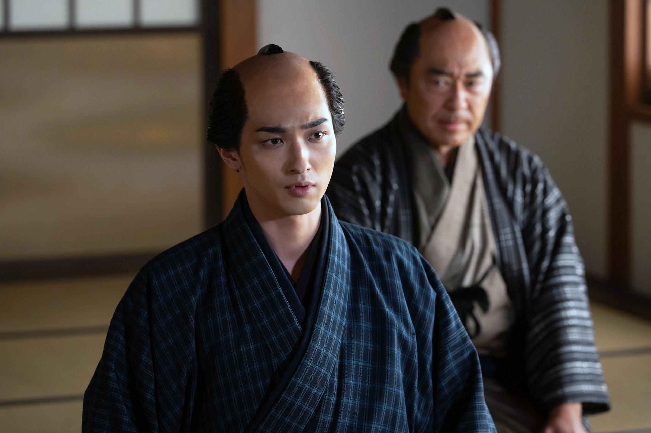 大河ドラマ「べらぼう」第23回より。終盤、扇屋宇右衛門（山路和弘）に連れられて現れた「奥の手」の後ろ姿と対峙する蔦重（横浜流星）。この人物の正体とは？