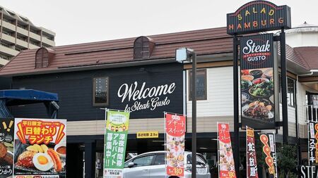 ステーキガストの食べ放題コースに挑戦する様子。テーブルに運ばれた肉料理とサイドメニューが並ぶ。