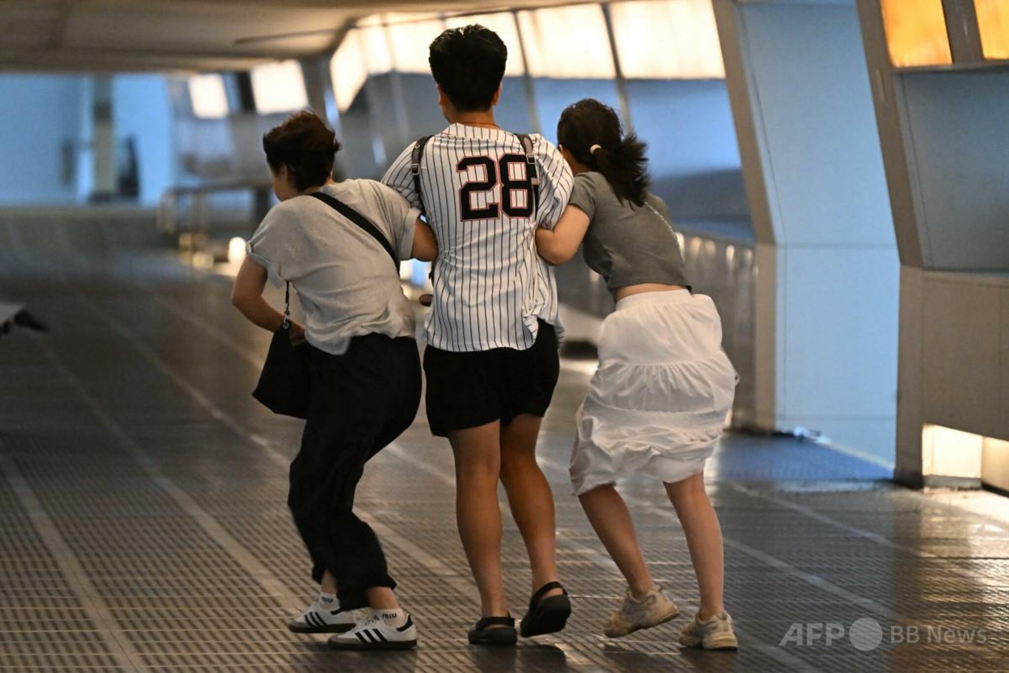 香港中環（セントラル）で強風にさらされる街並みと、台風6号「ウィパー」の影響を示す荒れる気象状況（2025年7月20日撮影）。