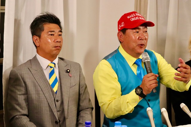 NHK党代表の立花孝志氏（右）が神戸市内の開票センターで参院選の結果を見守る様子。左は斉藤健一郎参院議員。
