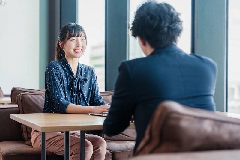 職場での上司と部下のコミュニケーションの課題を示す会議室の様子