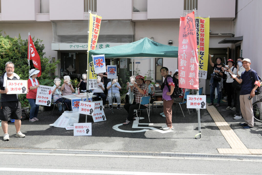 2024年7月10日、大阪市西成区の「やまき介護すてーしょん」前で、訪問介護事業閉鎖に抗議するケアワーカーズユニオン山紀会支部と支援者らの様子