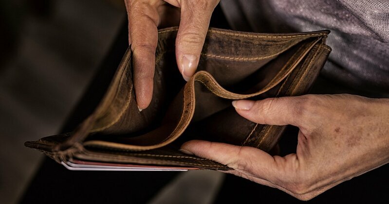日本の年金制度と生活保護の現状を示す高齢者の手元