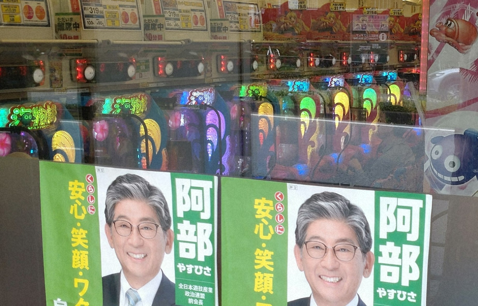 パチンコ店の窓に貼られた参院選候補者のポスター：業界の政治活動と密接な関係