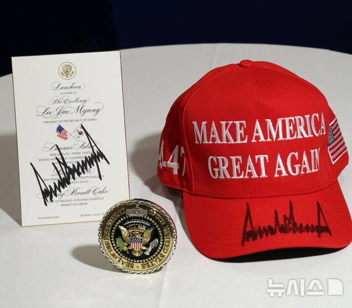 米韓首脳会談の関連品：ホワイトハウス記念メダルとトランプ氏サイン入りMAGA帽子の写真