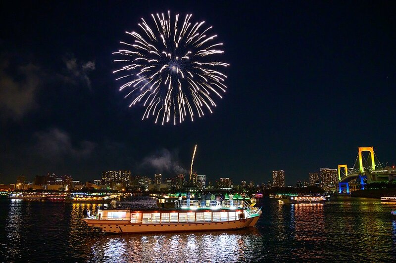 高層マンションから望む都市の夜景、しかし期待した花火の眺望が失われる可能性を想起させる景観。不動産購入時の眺望トラブルの象徴。