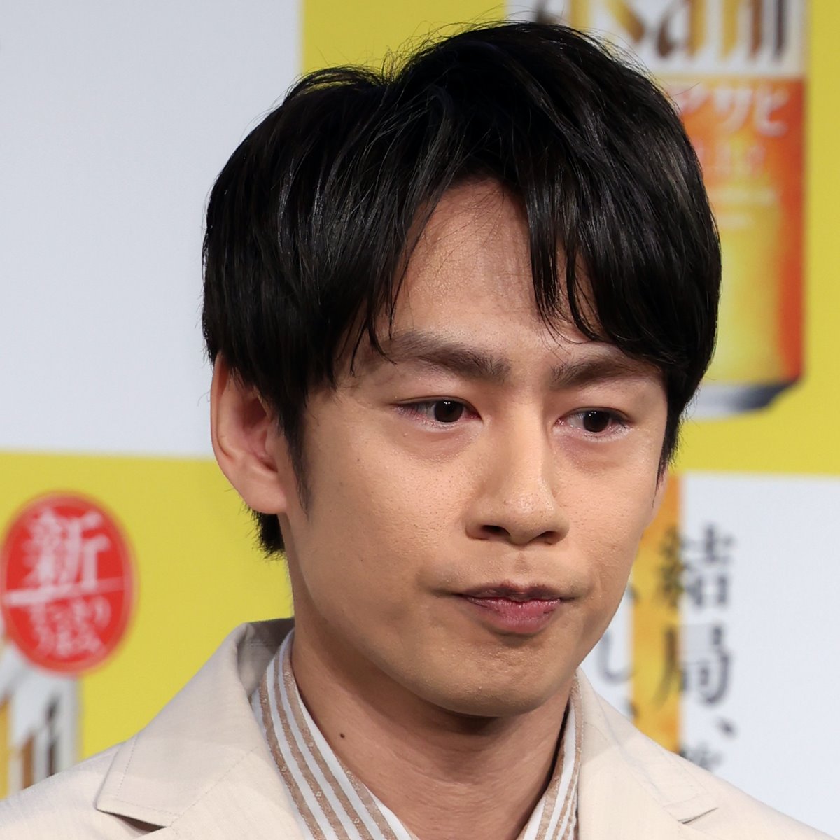 中丸雄一がカメラに向かって笑顔を見せる様子。