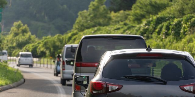 自動車専用道路を走行中の車。歩行者との接触事故の危険性を表現