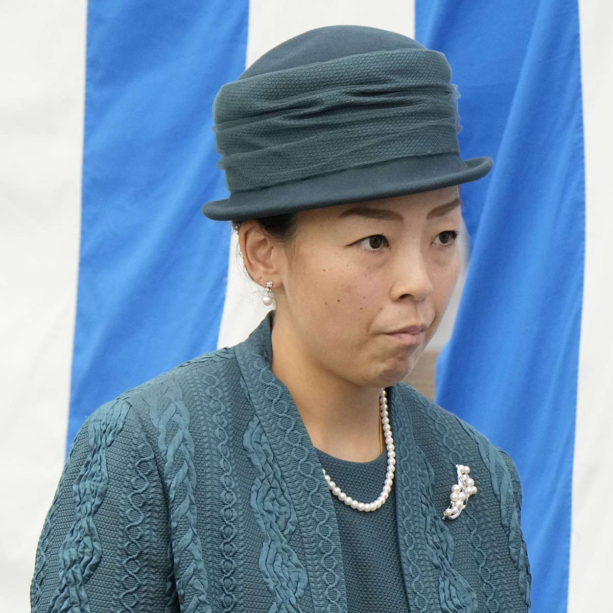 深い海のようなブルーグリーンのセットアップに身を包み、ピンキーリングを着用された瑶子さま