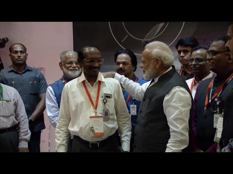 シヴァン所長ら探査機チームをたたえて退出するモディ首相 ISRO中継画像より