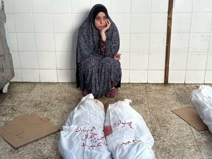 子どもの遺体の前で茫然とする母親（撮影・ガザ市民）