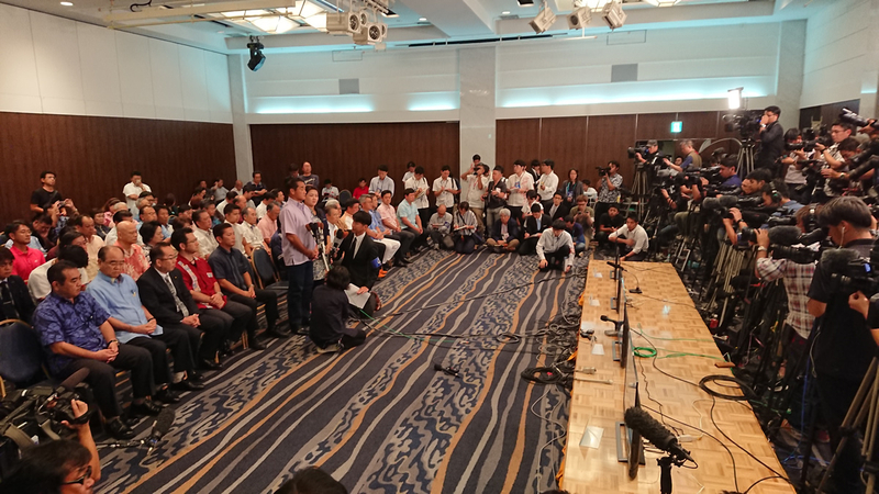 敗戦の弁を述べる佐喜眞氏(ANAクラウンプラザ、9/30、筆者撮影)