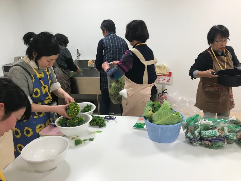 菜の花を洗う人、ジャガイモの皮をむく人、買い物へ行く人・・それぞれだ（筆者撮影）