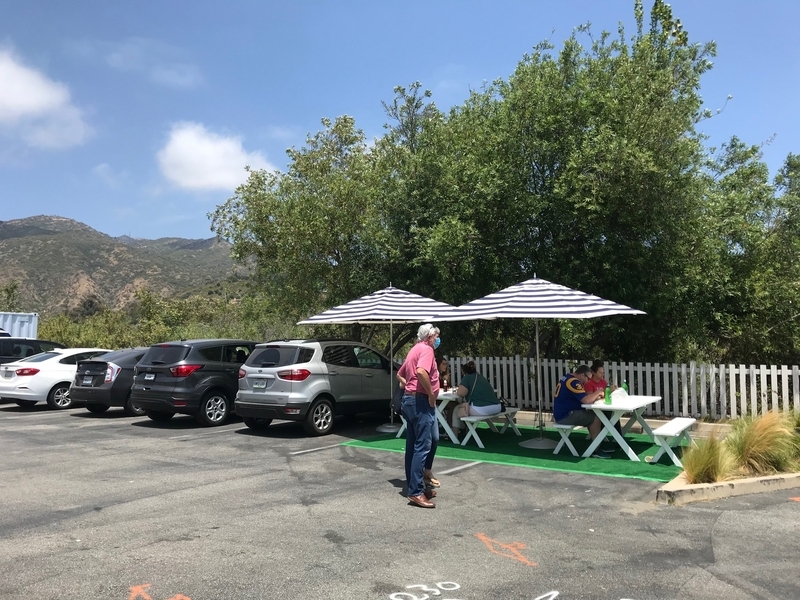 駐車場の一部にパラソルとテーブルを配置して、サービスするレストランもある。筆者撮影