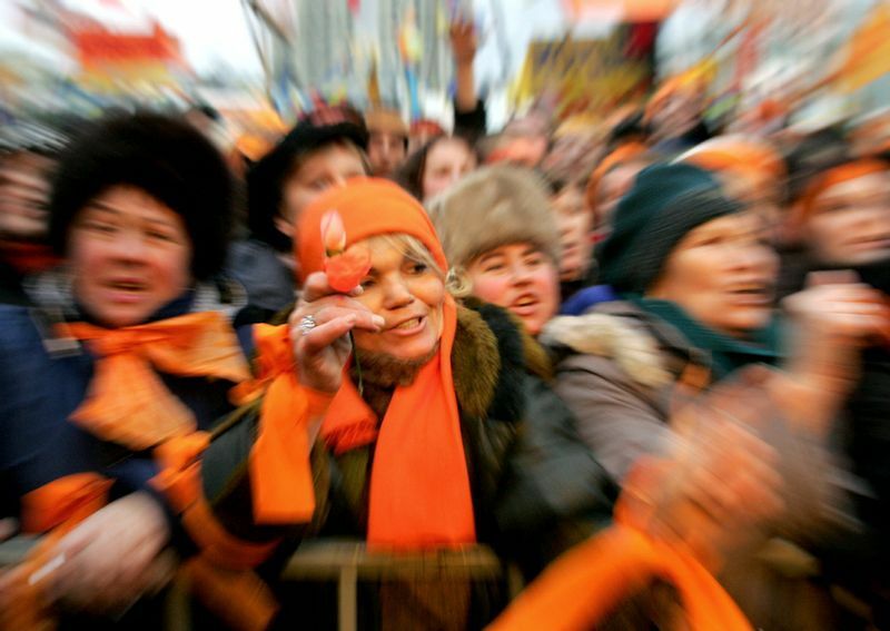 オレンジ色のスカーフを身に着けて、野党指導者支持のデモに参加する市民。2004年12月。