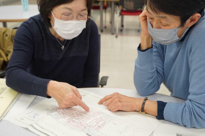 中央図書館の移転決定先のレイアウト案を見ながら議論する吉田真佐枝さん（左）と中澤晶子さん＝2023年3月24日、広島市中区（筆者撮影）