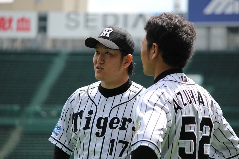 2回のマウンドへ上がる際、ベンチ前で打ち合わせをする小豆畑選手(右)と岩貞投手。