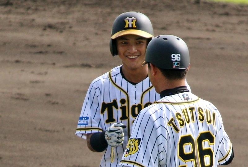 タイムリーを放って、一塁で筒井コーチに笑顔を見せる熊谷選手。