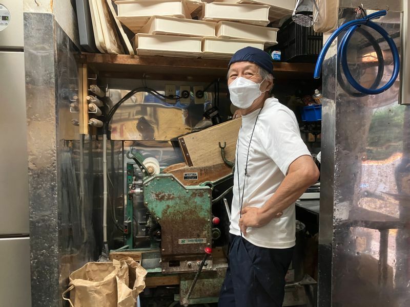 製麺機を操作する店主の前田浩男さん（筆者撮影）