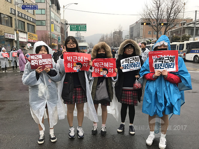 ろうそくデモに参加する女子中学生たち。2016年10月から17年3月まで約半年続いた「ろうそくデモ」は老若男女が参加する市民の集いの場であった。16年11月26日、筆者撮影。