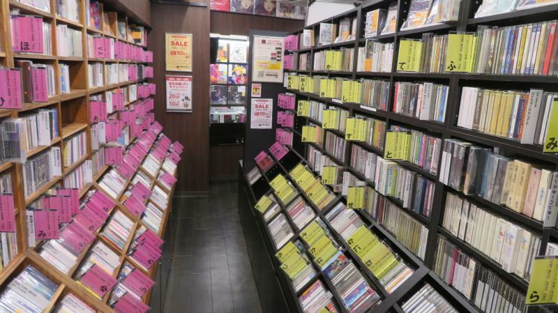 豊富な品揃えはまさに圧巻。赤いタグの棚はゲームミュージック、黄色いタグの棚にはアニソンのCDが陳列されている