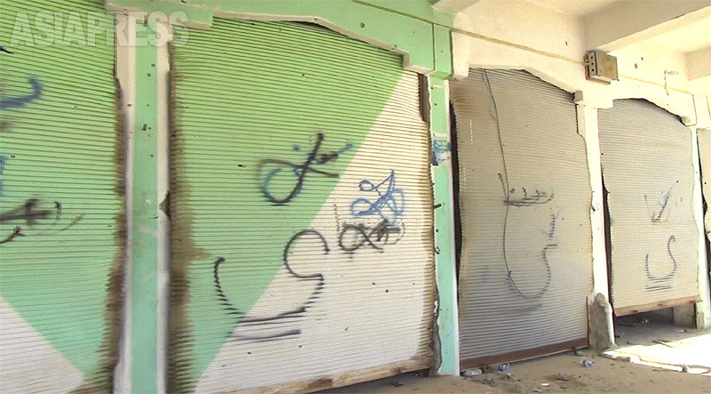 商店街のシャッターに書かれたスプレー文字。「ヤズディ」と記された店は荒らされたり、破壊されるなどしていた。（2016年・イラク北西部・シンジャル・撮影：玉本英子）