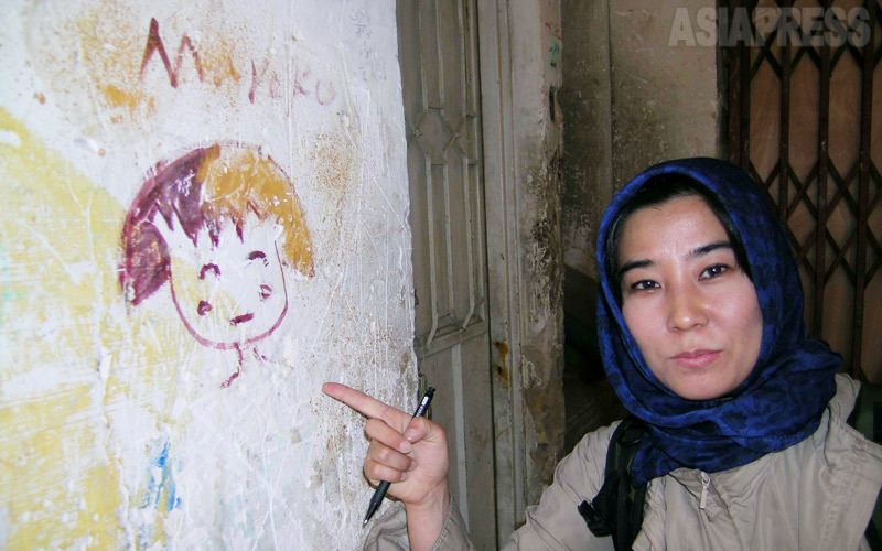 バグダッド市内のアパートの壁に、たまたま見つけた「まる子ちゃん」（写真右：筆者）。（2004年イラクで撮影：アジアプレス）