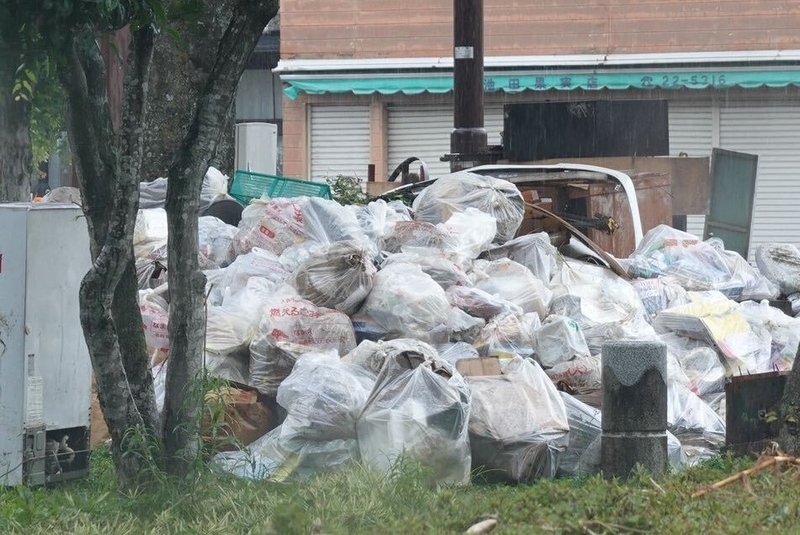 道路脇にはゴミ袋が積み上がっていた＝5日、熊本県人吉市