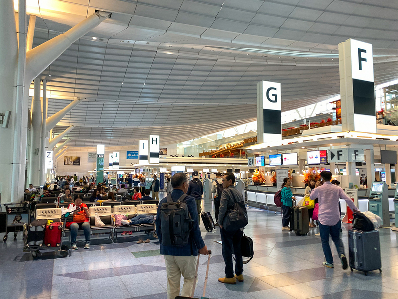 国際線ターミナルは午前10時半の時点では一部便の出発便があったが、外国人を中心に多くの人がソファで運航再開を待つ姿も見られた（10月12日午前10時30分、筆者撮影）