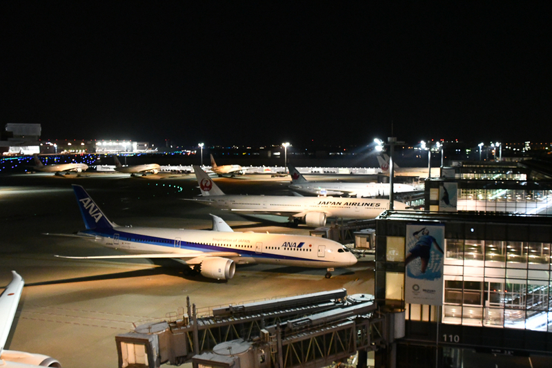 羽田空港第3ターミナルに駐機するANA機とJAL機(4月4日、午後10時30分頃撮影)
