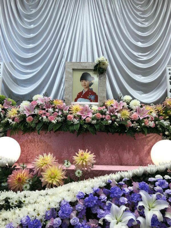 たくさんの花に彩られた耀子さんの遺影と祭壇（波多野さん提供）