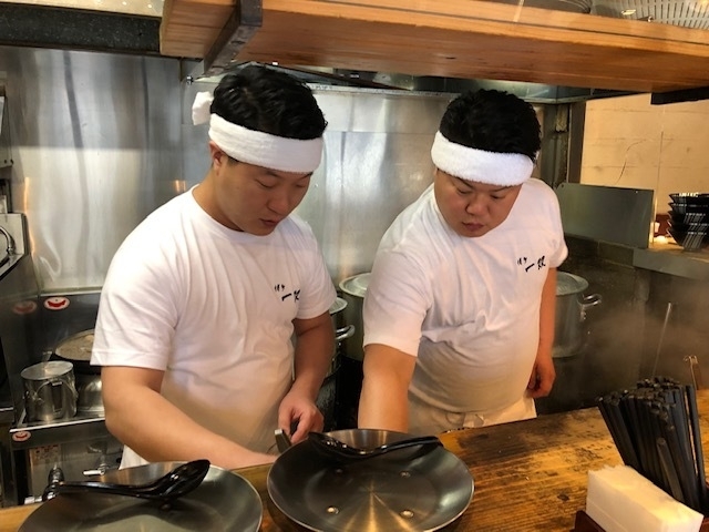 厨房に立つ兄の山田晶仁さん（右）と、弟の章仁さん。